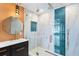 Bathroom featuring a large marble tiled shower with glass door and modern fixtures at 810 22Nd N St, St Petersburg, FL 33713