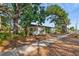 Quaint single-story home with white brick and mature trees, offering shade and curb appeal at 810 22Nd N St, St Petersburg, FL 33713