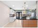 Modern kitchen with sleek appliances, dark countertops, and glass-front cabinets at 810 22Nd N St, St Petersburg, FL 33713