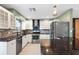 Modern kitchen with stainless steel appliances, light cabinets, and dark countertops at 810 22Nd N St, St Petersburg, FL 33713