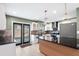 Well-lit kitchen with sleek appliances, dark countertops, and wooden island at 810 22Nd N St, St Petersburg, FL 33713