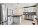 Bright kitchen features a large island with granite countertop and modern lighting at 810 22Nd N St, St Petersburg, FL 33713