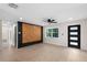 Bright living room with sleek ceiling fan, laminate floors, and an accent wall at 810 22Nd N St, St Petersburg, FL 33713