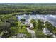 Stunning aerial view of the lakefront property with pool, lush landscaping, a dock, and a beautifully designed home at 8711 Brooke Angela Dr, Odessa, FL 33556