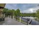 Large back deck overlooking a serene lake with mature trees at 8711 Brooke Angela Dr, Odessa, FL 33556