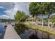 Lakeside backyard featuring a private dock and beautifully landscaped grounds at 8711 Brooke Angela Dr, Odessa, FL 33556