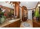 Bathroom with double vanity, granite counters, and dark wood cabinets at 8711 Brooke Angela Dr, Odessa, FL 33556