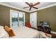 Comfortable bedroom with an ceiling fan, hardwood floors and large windows at 8711 Brooke Angela Dr, Odessa, FL 33556