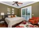 Bedroom with neutral walls, hardwood flooring, ceiling fan, and natural lighting at 8711 Brooke Angela Dr, Odessa, FL 33556