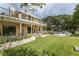 Backyard view of home with large covered patio overlooking pool and lake at 8711 Brooke Angela Dr, Odessa, FL 33556