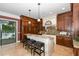 Open concept kitchen with an island, custom cabinetry, and a water view at 8711 Brooke Angela Dr, Odessa, FL 33556