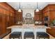Gourmet kitchen featuring a large island with seating, custom cabinets and modern appliances at 8711 Brooke Angela Dr, Odessa, FL 33556