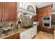 Modern kitchen boasts granite countertops, a range hood, stainless steel appliances and custom cabinets at 8711 Brooke Angela Dr, Odessa, FL 33556