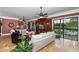 Bright living room featuring water views, a custom entertainment center, and comfortable seating at 8711 Brooke Angela Dr, Odessa, FL 33556