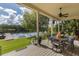 Inviting outdoor dining area on the covered patio with scenic lake views at 8711 Brooke Angela Dr, Odessa, FL 33556