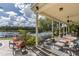 Covered patio with comfortable seating overlooking the tranquil lake and lush greenery at 8711 Brooke Angela Dr, Odessa, FL 33556