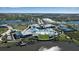 Aerial view of a community clubhouse with multiple pools, tennis courts, and lush landscaping by a lake at 8724 Ocean Tides Cv, Parrish, FL 34219