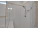 Shower featuring glass door, subway tile surround, and rainfall shower head at 8724 Ocean Tides Cv, Parrish, FL 34219