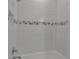 Bright bathroom featuring a shower with white subway tile and decorative accent border at 8724 Ocean Tides Cv, Parrish, FL 34219