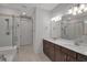 Bathroom features a double sink vanity, granite counter top, tile flooring, and glass enclosed shower at 8724 Ocean Tides Cv, Parrish, FL 34219