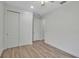 Bedroom with wood-look floors, double closet, and neutral paint at 8724 Ocean Tides Cv, Parrish, FL 34219