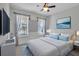 Stylish bedroom with a ceiling fan, plenty of light, and a serene coastal-themed décor at 8724 Ocean Tides Cv, Parrish, FL 34219