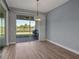 Bright dining area with large sliding glass door leading to outdoor patio and a well-lit interior at 8724 Ocean Tides Cv, Parrish, FL 34219