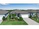 Charming one-story home with a well-kept lawn, inviting walkway and two car garage at 8724 Ocean Tides Cv, Parrish, FL 34219