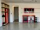 Organized garage featuring a red tool bench with cabinets and a rolling stool at 8724 Ocean Tides Cv, Parrish, FL 34219