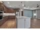 Bright kitchen featuring a central island, ample counter space, and stainless steel appliances, seamlessly connected to living area at 8724 Ocean Tides Cv, Parrish, FL 34219