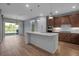 Modern kitchen featuring a large island with barstool seating and stainless steel appliances at 8724 Ocean Tides Cv, Parrish, FL 34219