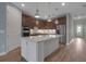 Modern kitchen with white cabinetry, stainless steel appliances, and a central island, perfect for culinary enthusiasts at 8724 Ocean Tides Cv, Parrish, FL 34219