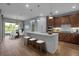 Modern kitchen featuring an island with barstool seating, stainless steel appliances, and pendant lighting at 8724 Ocean Tides Cv, Parrish, FL 34219