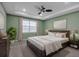 Comfortable main bedroom featuring a ceiling fan, large window and green walls at 8724 Ocean Tides Cv, Parrish, FL 34219