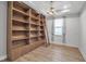 Bright office space featuring custom built-in shelving with ladder and modern lighting at 8724 Ocean Tides Cv, Parrish, FL 34219