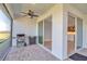 Screened-in patio featuring brick flooring, ceiling fan, and outdoor kitchen area with stainless steel grill at 8724 Ocean Tides Cv, Parrish, FL 34219