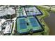 Aerial view of tennis courts featuring well-maintained courts surrounded by lush landscaping and community facilities at 8724 Ocean Tides Cv, Parrish, FL 34219