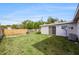 The backyard is an outdoor area with green grass, a patio, a grill, and a wooden fence for privacy at 9048 94Th St, Seminole, FL 33777
