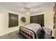 Cozy bedroom featuring neutral walls, a ceiling fan, and a decorative mirror at 9048 94Th St, Seminole, FL 33777