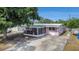 Charming home featuring a screened porch, covered entry, and spacious driveway at 9048 94Th St, Seminole, FL 33777