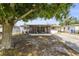 Charming home featuring a screened porch and mature landscaping in the front yard at 9048 94Th St, Seminole, FL 33777