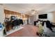 Kitchen view with light oak cabinets and open layout to the living room with pink carpet at 9048 94Th St, Seminole, FL 33777