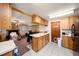 Open kitchen connected to the living area, featuring wood cabinets and a laundry room at 9048 94Th St, Seminole, FL 33777