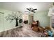 View of living room with light-green walls, vinyl plank flooring and fireplace decorated with a tree decal at 9048 94Th St, Seminole, FL 33777