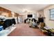 View of living room with pink carpet, brick fireplace, and an open view to the kitchen at 9048 94Th St, Seminole, FL 33777