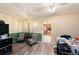 Cozy living room with wood-look flooring, wainscoting, decorative light fixture, and open doorway to the kitchen at 9048 94Th St, Seminole, FL 33777