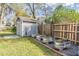 Backyard storage shed with garden beds, privacy fence, and mature landscaping at 917 Silver Ridge Way, Valrico, FL 33594