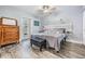 Bedroom featuring gray walls, wood-look flooring, a ceiling fan, and an exterior access door at 917 Silver Ridge Way, Valrico, FL 33594