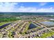 Aerial view of a residential neighborhood featuring numerous homes, lakes, and green spaces at 9412 Lemon Drop Loop, Ruskin, FL 33573