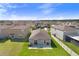 Backyard with a patio and well-maintained lawn, surrounded by a neighborhood of similar houses at 9412 Lemon Drop Loop, Ruskin, FL 33573